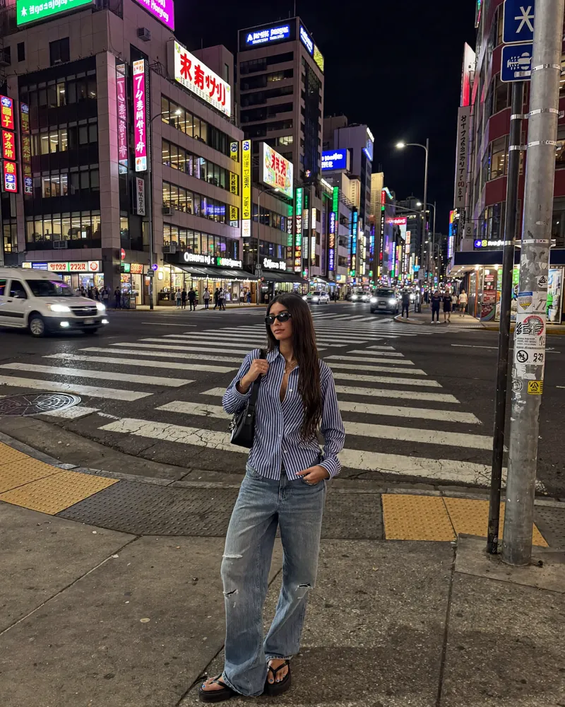 AI-generated image of Gabi at a neon-lit Shinjuku crossing in Tokyo at night